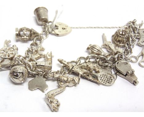 A MODERN SILVER CURB LINK 'CHARM' BRACELET on a padlock clasp, Birmingham 1992, hung with various charms including: a parking