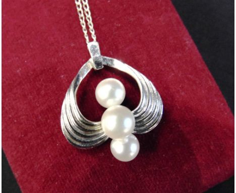 MIKIMOTO CULTURED PEARL THREE STONE PENDANT  of open double-scroll design, maker's mark and stamped 'S' for silver, 27mm high