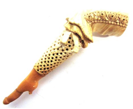 A MEERSCHAUM PIPE CARVED IN THE FORM OF A LADY'S STOCKINGED LEG  with an amber mouth-piece (broken and repaired), overall 12.