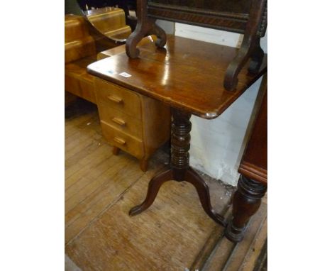 A late Georgian tripod table, raised on floral carved column supports.