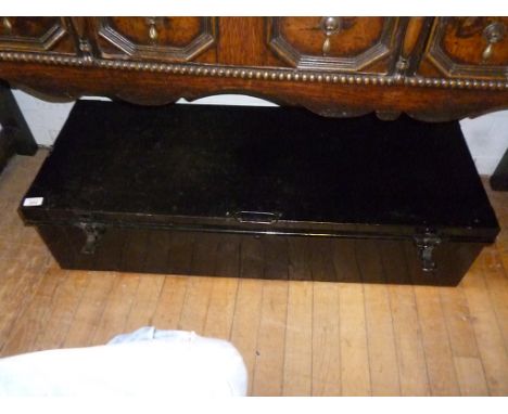 A large black painted tin lidded trunk.