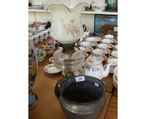 An Eastern brass jardiniere with chased decoration along with a Victorian oil lamp with a clear glass reservoir and ebonised 