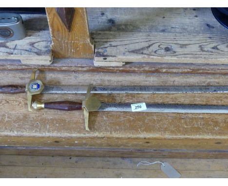 A pair of Wilkinson Sword commemorative swords, each with a hardwood turned handle and one applied with a London crest.