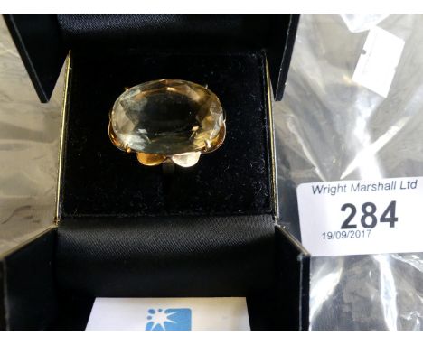 A 9ct gold dress ring with a large smoked quartz stone.