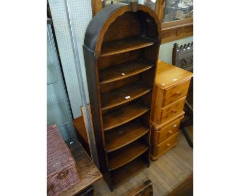 A mahogany seven shelf bowfront waterfall bookcase with arched top.