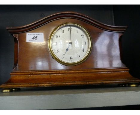 An Edwardian mahogany mantel clock, with a silvered dial and arched case.