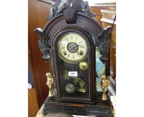 A late 19th/early 20th Century stained hardwood American mantel clock by Asonia with a white enamel dial two train movement.