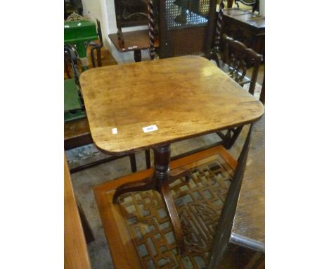 An early 19th Century mahogany occasional table, with oblong top with rounded edges, raised on ring turned support terminatin