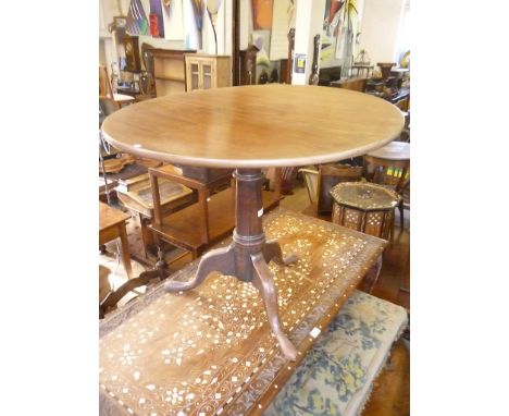 A Georgian oak tripod tilt top circular occasional table, with bird cage action, turned wood support raised on three splayed 