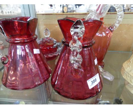 Four pieces of assorted cranberry glassware to include two jugs, decanter with clear stopper, also a Victorian green glass ju
