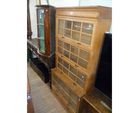 A light oak Globe Wernicke style four tier bookcase with drawer beneath.