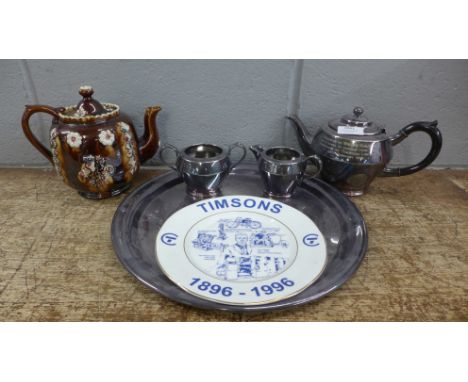 A 19th Century bargeware teapot, repaired chip on the lid, a three piece plated tea service with an inscription and a Timsons