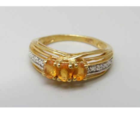 A silver gilt fire opal and diamond accent ring, K 