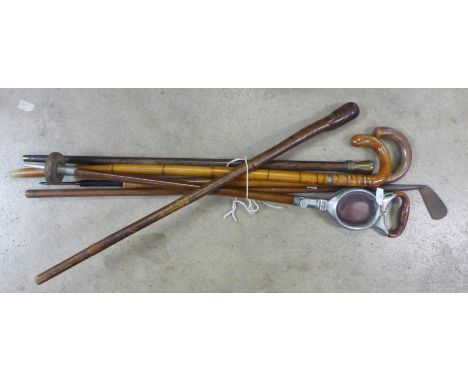 Six walking sticks including a shooting stick, two umbrella sticks, one with golf head top and brass topped club/stick 