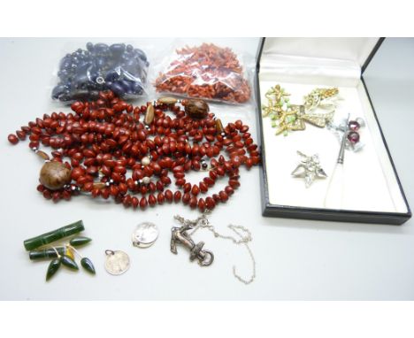 A collection of jewellery including a carved jade brooch, coral necklaces, (requiring fasteners), a silver anchor brooch, a/f