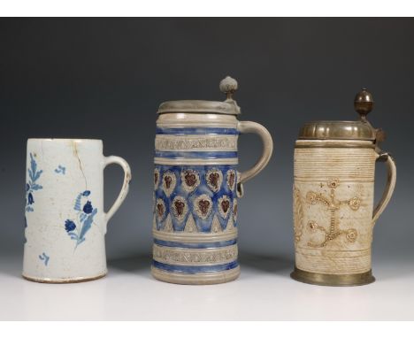 Duitsland, drie keramische pullen, 18e/19e eeuw, één Delftware met blauw en rood floraal patroon, en twee steengoed met tinne