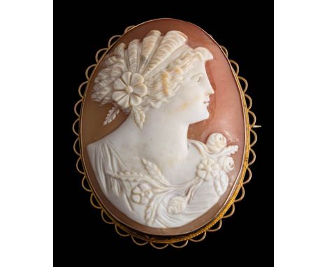An oval shell cameo portrait brooch: depicting the goddess of Spring within a gold frame, 55mm long overall, 16.5gms gross we