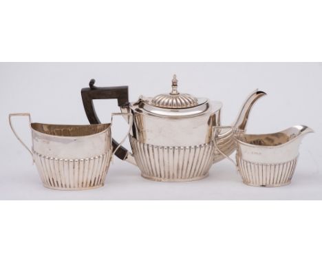 An Edward VII silver three-piece bachelor's tea service, maker William Aitken, Birmingham, 1903: of oval outline with half re