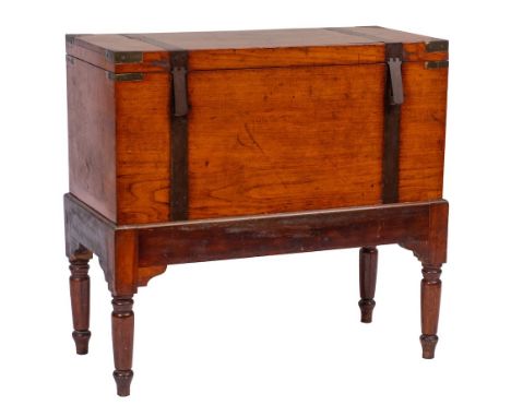 A 19th Century teak and brass banded and mounted trunk on a stained beech stand:, the trunk with a hinged top bearing the nam