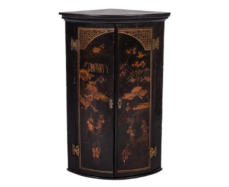 An 18th Century black lacquer and chinoiserie bow-fronted hanging corner cupboard:, with a moulded cornice, enclosed by a pai