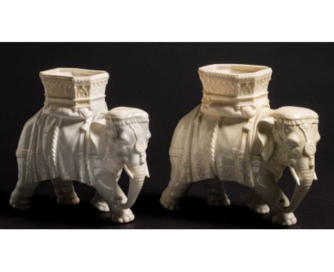 Two Royal Worcester elephant vases modelled by James Hadley: in the white, each with elaborate howdah and cloths, impressed '