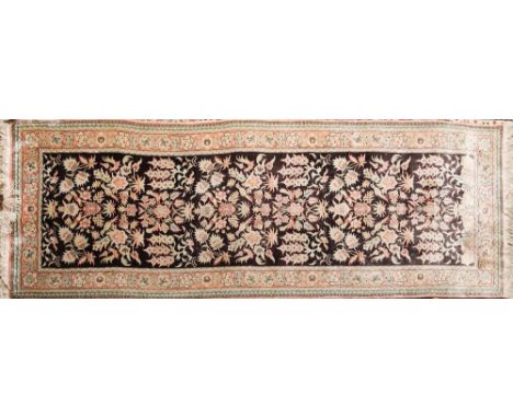 A Kashmir runner:, the chocolate brown field with an all over design of birds amidst flowering shrubs, enclosed by a main ros