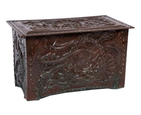 An Arts and Crafts embossed copper rectangular trunk of Newlyn type:, the overhanging hinged top decorated with twin dolphins