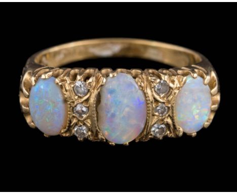 An 18ct gold, opal and diamond nine-stone ring: with three oval opals separated by rows of small diamonds, ring size Q 1/2. 