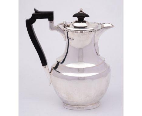 A George V silver hot water jug, maker Atkin Brothers, Sheffield, 1911: of ovoid form with bobbin turned border, on an oval f