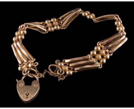 An Edwardian three bar gate-link bracelet: stamped '15', with attached heart-shaped padlock clasp, approximately 19gms gross 