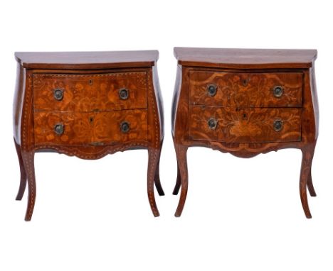 A 19th Century Dutch mahogany and floral marquetry serpentine fronted bombe commode:, the panels of flowers and foliage withi