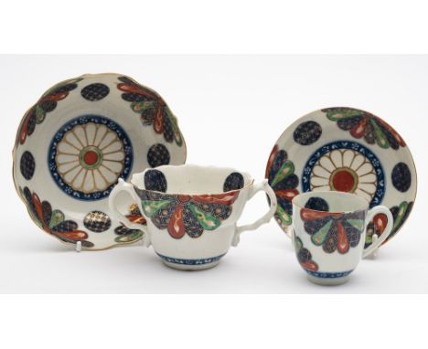 A First Period Worcester two-handled chocolate cup and stand and a similar coffee cup and saucer: painted in the 'Old Japan F