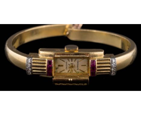 A lady's 18ct gold 'Enicar' manual wind, expanding bangle wristwatch: the rectangular dial with baton markers, mesh cover and