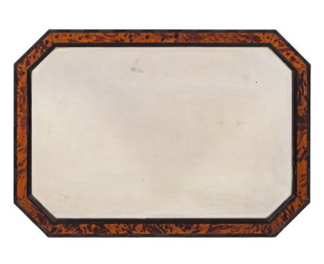A blonde tortoiseshell and ebonised frame octagonal mirror:, the bevelled plate within a reeded and ripple moulded surround w