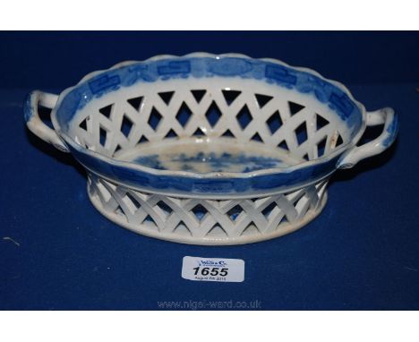 An early Staffordshire creamware, oval openwork, two handled Basket with blue transfer print border and willow pattern scene 