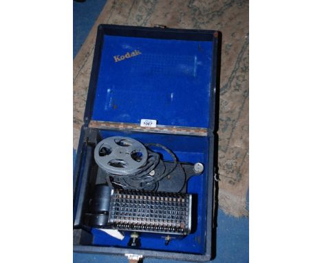 A cased circa 1940 Kodak Cine 8mm projector. Black enamel finish, with drive belts, and reel 8mm finish.