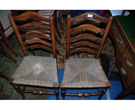 A pair of early 19th c. Oak, ladder back Dining Chairs, five bar backs in turned supports, rope seats on turned, pad foot leg