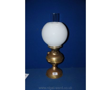 A Brass oil Lamp with white glass shade.