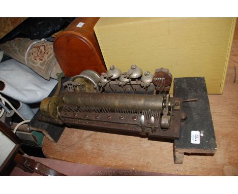 A mid Victorian Music Box movement, probably Swiss, mounted on Pine blocks, having chrome drum with six beaters, shaped wood 