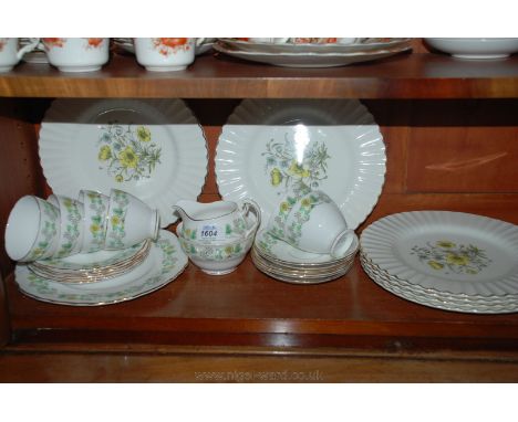 A bone china Teaset comprising six cups and saucers, six tea plates, milk jug, sugar bowl and bread and butter plate, plus si