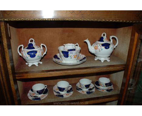 A Gaudy Welsh 'tulip' pattern Teaset comprising four trios, teapot, lidded sucrier, two bread and butter plates, slop bowl an