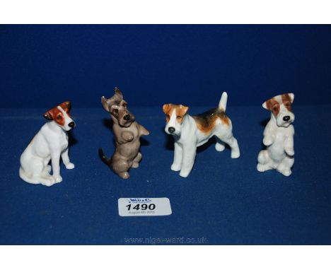 Three Royal Doulton 'Terrier' figures and a small Royal Worcester dog.