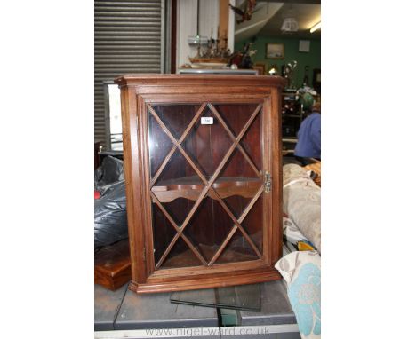 A modern bespoke made Mahogany wall hanging glazed Corner Cabinet, having moulded cornice over plain mahogany frame with cent