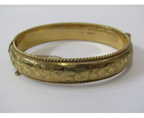 GOLD BANGLE, 9ct yellow gold hinged bangle with foliate engraved decoration, 20.1 grams 