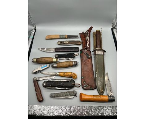 A Collection of vintage hunting and tool working knives. Includes military dock yard knife and Military style knife with frog