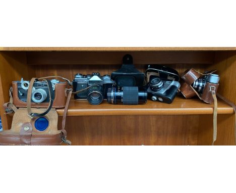 A collection of vintage cameras to includes argus, Zenit-e, Karl Zeiss lense etc 