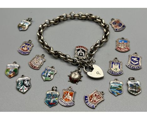 Silver charm bracelet together with silver and enamel souvenir shield fobs. 