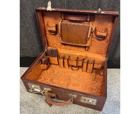 Antique/ vintage brown leather travel case has fitted compartment interior with various travelling utensils. Exterior has an 
