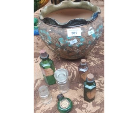 Hand painted Doulton Lambeth bowl along ith various vintage medicine bottles. 