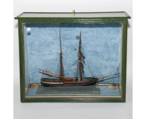 Model sailing boat in glazed display case.  The actual boat was built at Bosham Boatyard for clients and this was the custome